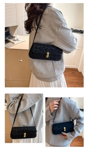 Detailed close-up of leopard print shoulder bag with gold J-buckle and suede texture