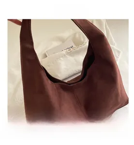 Close-up of deep brown suede tote bag featuring a minimalist retro texture and soft design