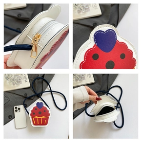 Detail view of cupcake shaped crossbody bag with blue woven strap and gold zipper