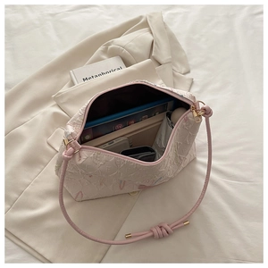 Interior view of pink quilted tote bag showing capacity for tablet, umbrella and phone