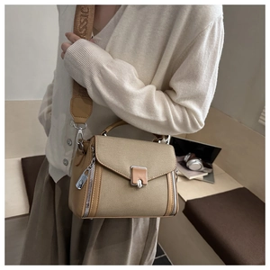 Close-up of a vintage color-block handbag with a wide embroidered CLASSIC strap