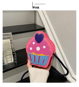 Close-up of pink cupcake-shaped kids shoulder bag with heart detail and blue rope strap