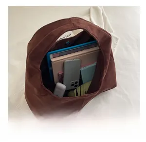 Top view of spacious brown suede tote bag showing large capacity for tablet and daily items
