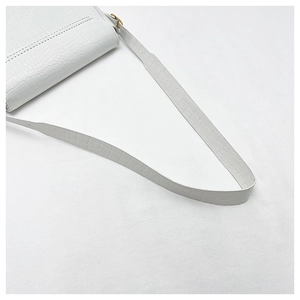 Detailed close-up of white crocodile pattern PU leather bag with adjustable shoulder strap