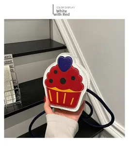 Detail of cupcake shaped crossbody bag with colorful contrast and blue heart decoration
