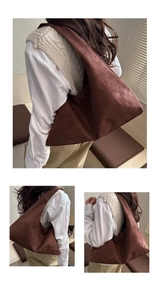 Detail of dark brown matte leather hobo bag showing its large capacity and soft texture