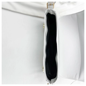 Detailed interior of a white croc-embossed handbag showing black lining and gold metal buckle