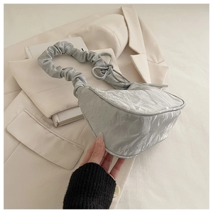 Detail of silver metallic hobo bag with crinkled texture and pleated handle
