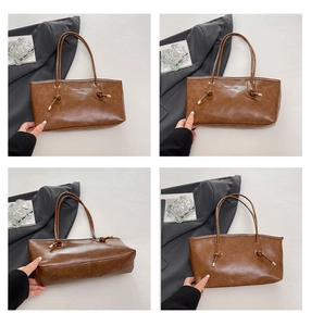 Detail view of brown retro tote bag with knotted handle and elegant metal decorative ends