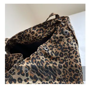 Close-up of leopard print canvas tote bag featuring secure silver magnetic snap closure