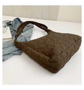 Detail of coffee brown cloud bag featuring star quilting and lightweight puffy nylon fabric