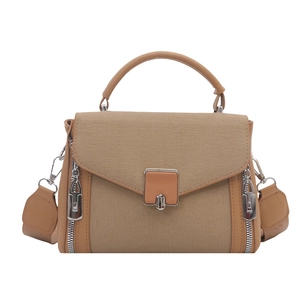 Minimalist khaki canvas and leather crossbody bag with metal buckle and top handle