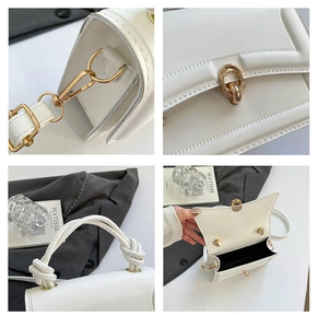 Detail view of white handbag featuring woven handle, golden hardware and interior space