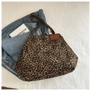Detail shot of leopard print canvas tote bag with front pocket and durable straps
