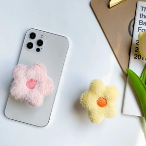 Close-up of soft plush flower and star phone sockets in pink and yellow colors