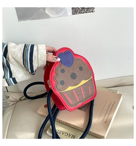 Detail of red cupcake crossbody bag featuring blue heart accents and thick rope strap