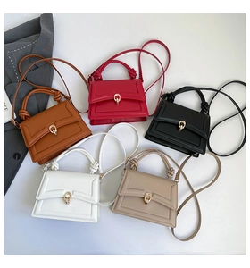 Top-down view of mini square crossbody bags with knotted handles and gold horseshoe buckles
