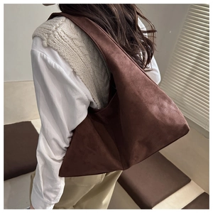 Detail of dark brown faux suede hobo bag showing large capacity and soft matte texture