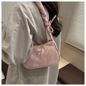 Pink pleated underarm bag with silver bow detail and stylish knotted shoulder strap