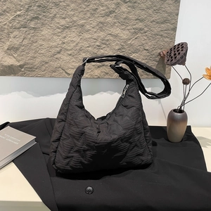 Black quilted bubble cloud hobo bag with star pattern and wide shoulder strap