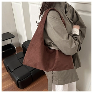 Close-up of the vintage matte dark brown suede texture on this minimal shoulder bag