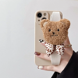 Cream iPhone case with wrist strap featuring a cute plush bear and leopard bow