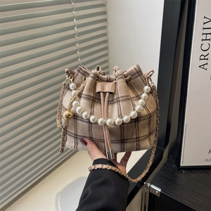 Checkered tweed bucket bag with pearl handle and golden ball chain strap detail