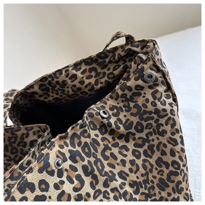 Detailed macro view of leopard print canvas tote bag with magnetic snap closure buttons
