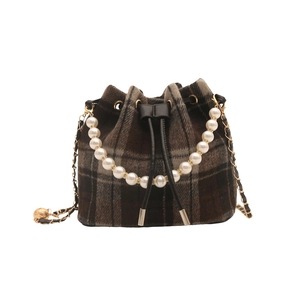 Chic brown plaid bucket bag with pearl top handle and metal chain strap on white background