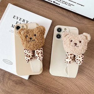 Detail of 3D plush bear phone case with leopard bow and functional wrist strap