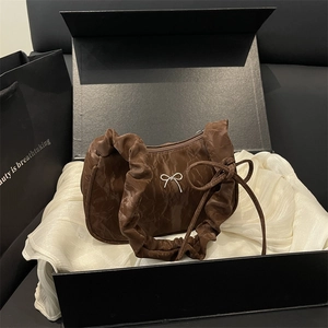 Brown ruched fabric shoulder bag with silver bow detail in a gift box packaging