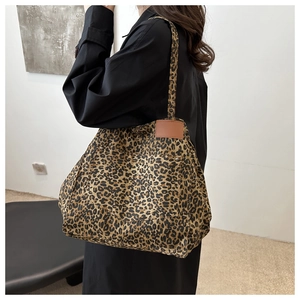 Leopard print tote bag detail showing shoulder strap and side view on model outfit