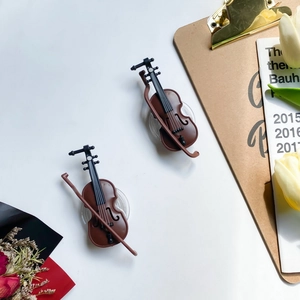 Detailed close-up of mini violin phone socket with violin bow and transparent base