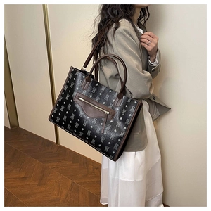 Detailed view of large capacity bear print tote bag styled with a grey blazer outfit