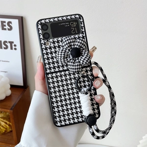 Houndstooth Samsung Z Flip case with large floral ornament and hand strap handle