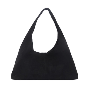 Large black suede tote bag with vertical stitching and spacious interior for commuting