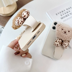Detail of white iPhone case with plush 3D bear, leopard bow and leather wrist strap