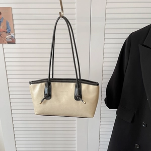 Sac fourre-tout beige minimaliste avec nœuds noirs et embouts métalliques dorés