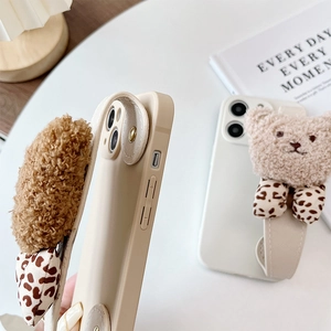 Detail view of iPhone case with 3D plush bear head and leopard bow wrist strap