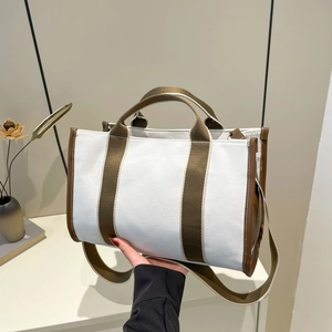 Fashionable large capacity canvas tote bag with contrast brown leather trim and shoulder strap