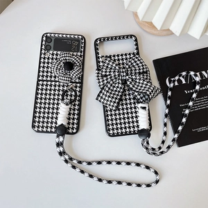 Detail of houndstooth phone case for Samsung Z Flip with 3D flower and ribbon strap