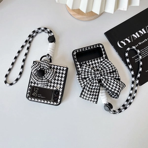 Detail of black and white houndstooth phone case with 3D flower and lanyard for Z Flip