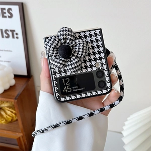 Detail of Galaxy Z Flip case featuring houndstooth pattern with 3D flower and lanyard
