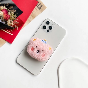 Pink plush teddy bear phone socket with blue striped hat on white smartphone