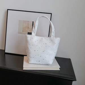 White star pattern tote bag in soft canvas on a minimalist table with home decor