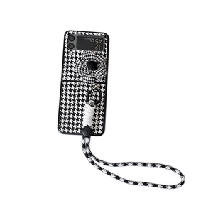 Samsung Galaxy Z Flip case set featuring black and white houndstooth pattern and lanyard