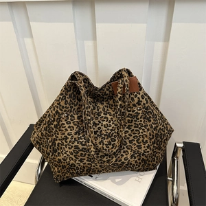 Large leopard print canvas tote bag on a chair, showcasing stylish urban commuter design