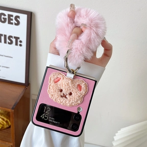 Pink Samsung Galaxy Z Flip case detail with plush bear embroidery and fur handle strap