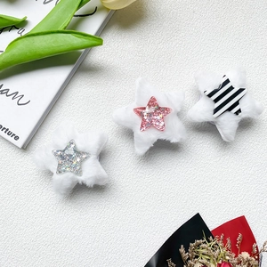 Detailed close-up of three white plush star-shaped phone sockets with sequin centers