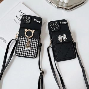 Close-up of crossbody iPhone case with houndstooth card wallet and bow detailing
